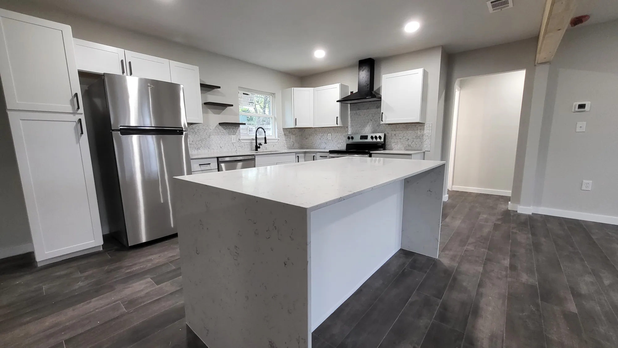 Finished KATO kitchen with white cabinetry and waterfall island